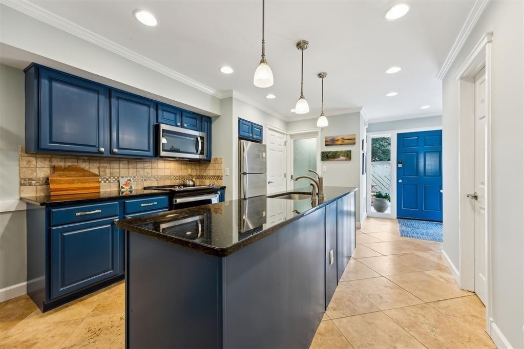 3033 Sea Marsh Road Fernandina Beach, FL 32034 - Photo 6 of 37 a kitchen with stainless steel appliances granite countertop a sink a stove and a refrigerator