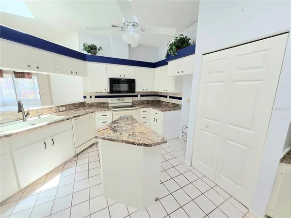 a kitchen with stainless steel appliances a refrigerator sink and microwave