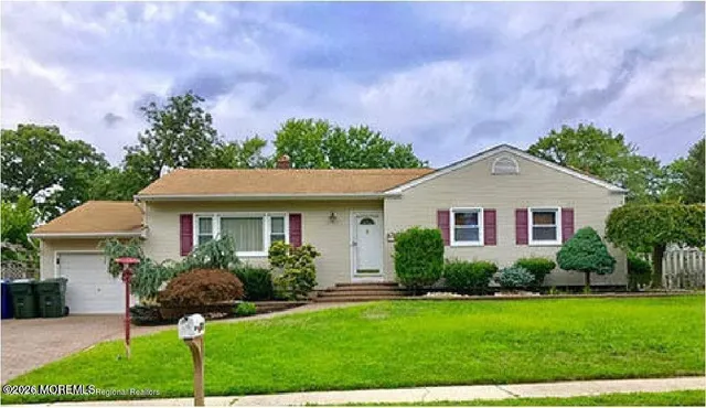 a front view of a house with a garden and plants