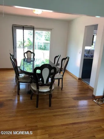 a dining room with furniture and wooden floor