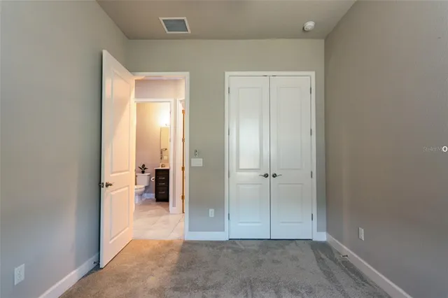 an empty room with a bathroom and a sink