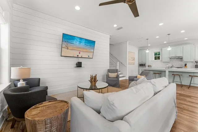 a view of a dining room with furniture large windows and wooden floor