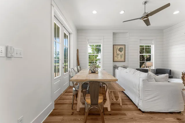 a view of a livingroom with wooden floor and furniture