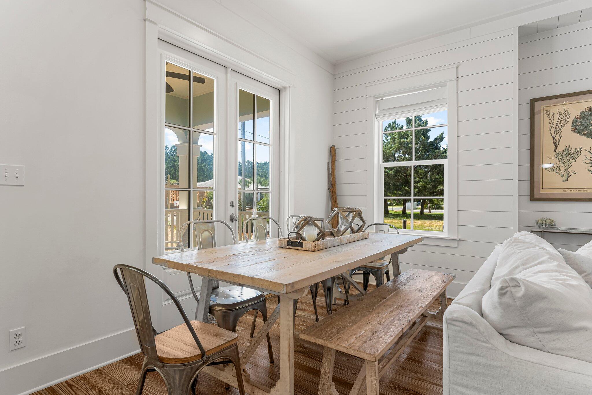 515 Seacrest Drive Inlet Beach, FL 32461 - Photo 14 of 62 a view of a dining room with furniture large windows and wooden floor