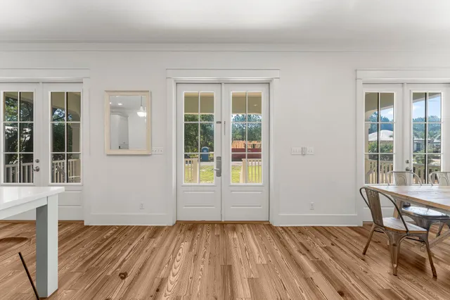 a view of a hallway with wooden floor and staircase