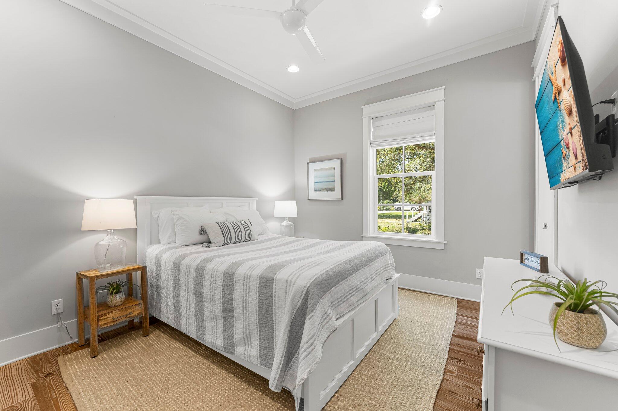 515 Seacrest Drive Inlet Beach, FL 32461 - Photo 29 of 62 a bedroom with a bed table and a window