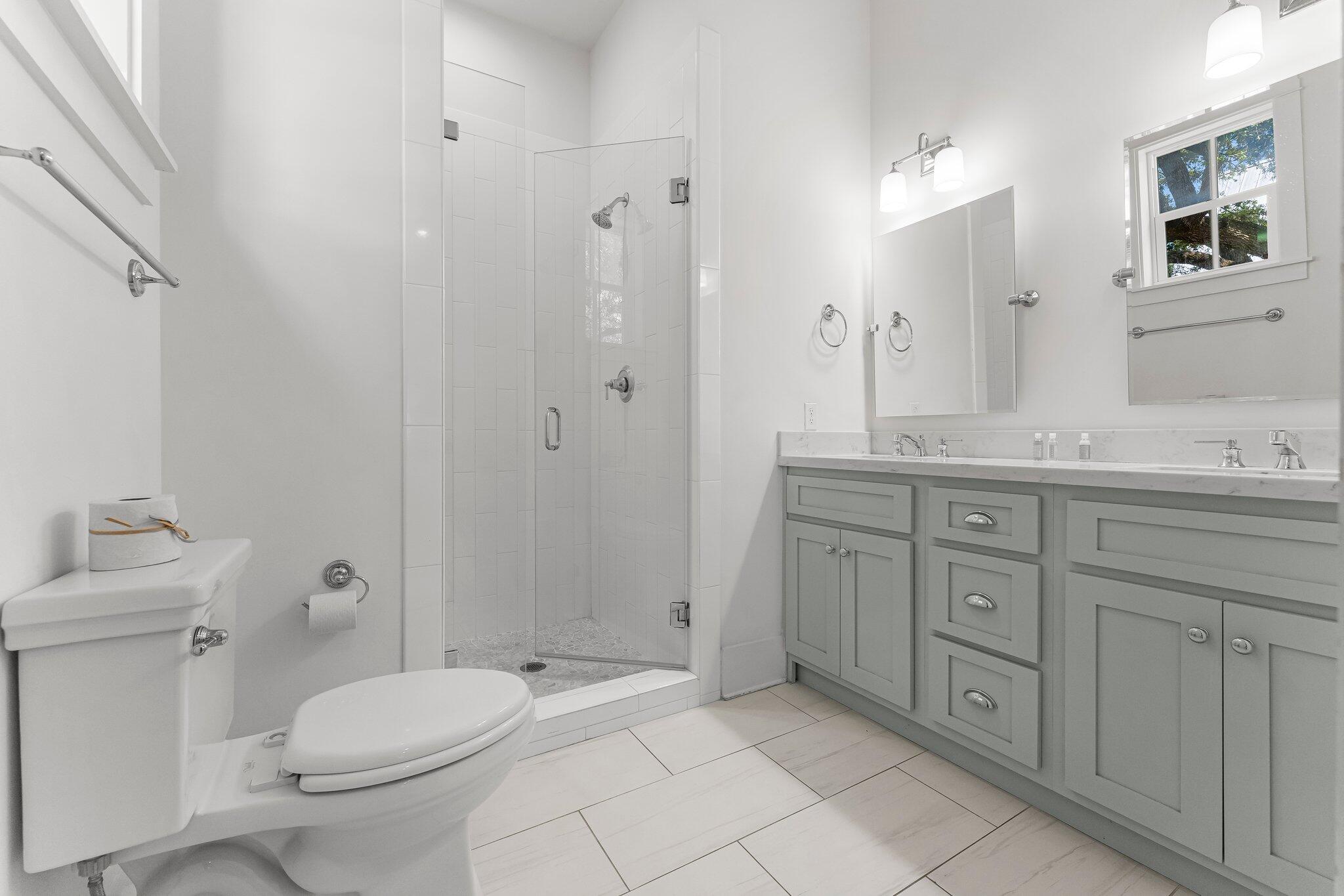 515 Seacrest Drive Inlet Beach, FL 32461 - Photo 31 of 62 a bathroom with a granite countertop toilet sink and mirror