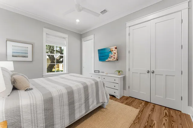 a bedroom with a bed and a potted plant