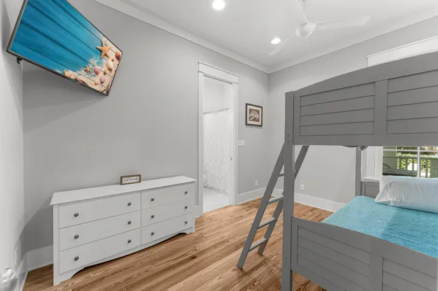 a room with furniture pool table wooden floor and a window