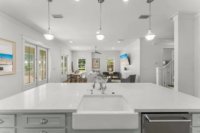 a kitchen with cabinets stainless steel appliances a sink and a stove
