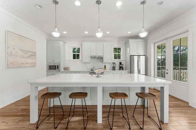 a kitchen with stainless steel appliances a refrigerator sink and cabinets