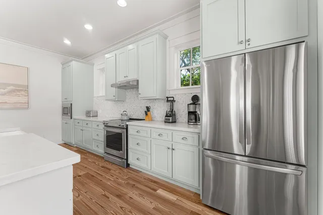 a living room with furniture a table and a large window