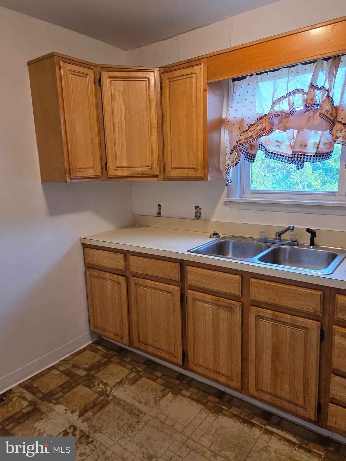 5706 Mitchell Road Levittown, PA 19057 - Photo 6 of 7 a kitchen with stainless steel appliances granite countertop a sink and cabinets