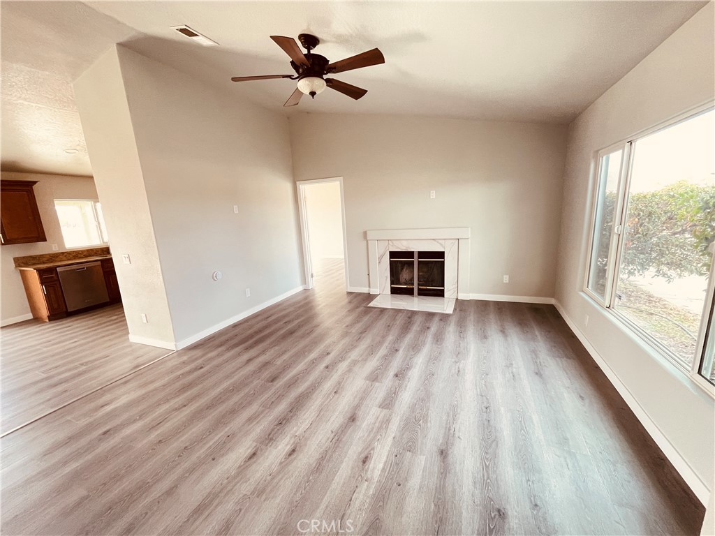 20891 Thunderbird Road Apple Valley, CA 92307 - Photo 12 of 45 a view of empty room with wooden floor and fan