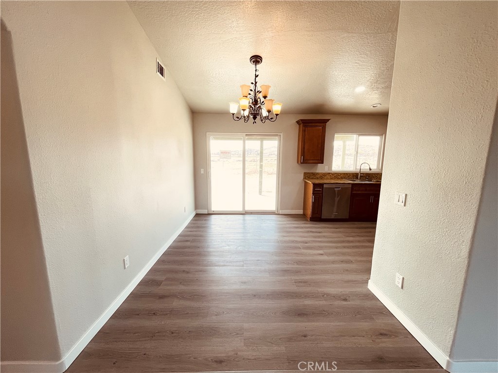 20891 Thunderbird Road Apple Valley, CA 92307 - Photo 15 of 45 a view of a room with wooden floor and window