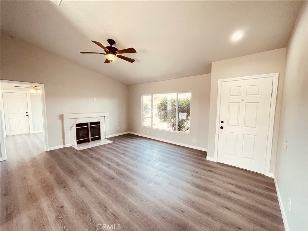 20891 Thunderbird Road Apple Valley, CA 92307 - Photo 23 of 45 wooden floor fireplace and windows in an empty room