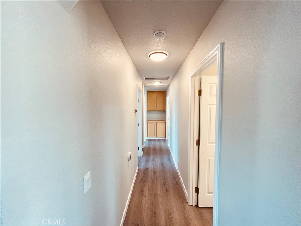 20891 Thunderbird Road Apple Valley, CA 92307 - Photo 26 of 45 a view of a hallway with wooden floor
