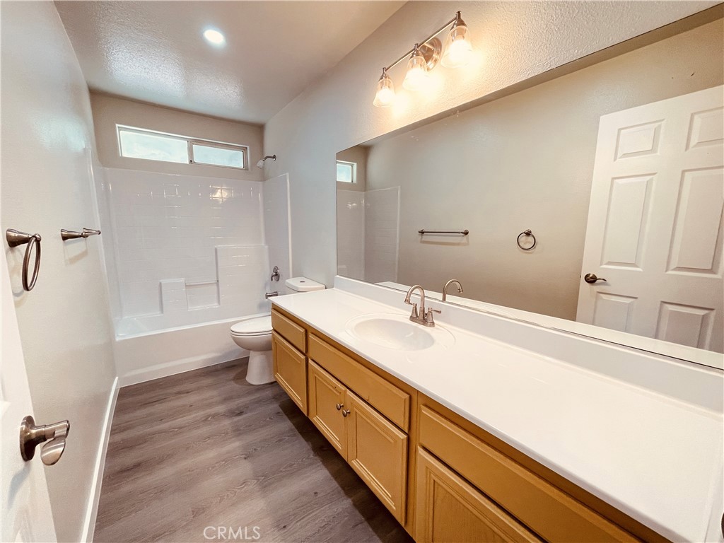 20891 Thunderbird Road Apple Valley, CA 92307 - Photo 27 of 45 a spacious bathroom with a double vanity sink toilet mirror and bathtub