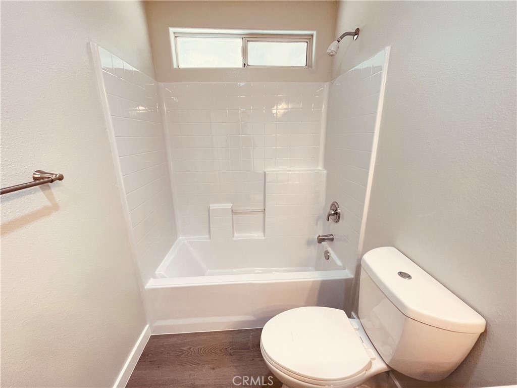 20891 Thunderbird Road Apple Valley, CA 92307 - Photo 28 of 45 a white toilet sitting next to a bath tub