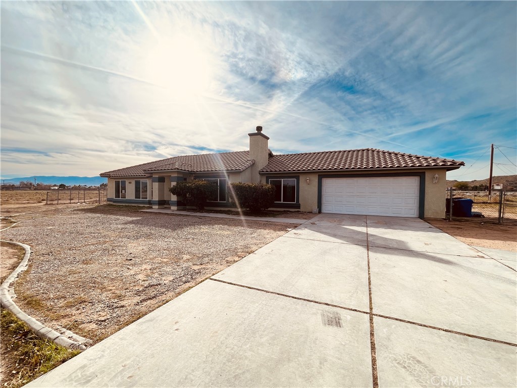 20891 Thunderbird Road Apple Valley, CA 92307 - Photo 9 of 45 a front view of a house with a yard