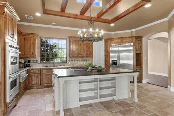 a kitchen with stainless steel appliances granite countertop a stove a sink and a microwave