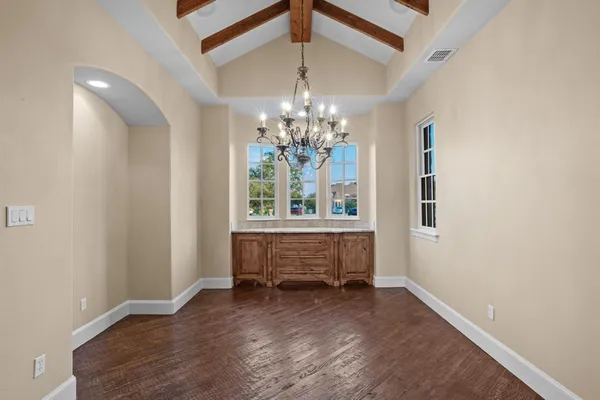 a bathroom with a toilet sink vanity and mirror