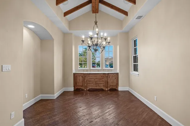 a bathroom with a toilet sink vanity and mirror
