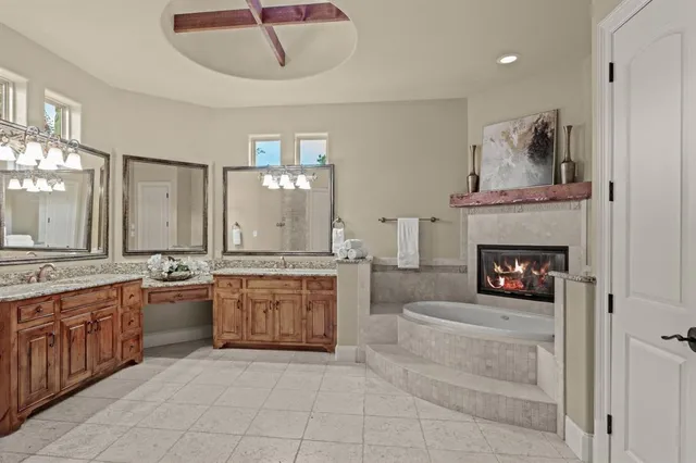 a bedroom with a bed and a fireplace