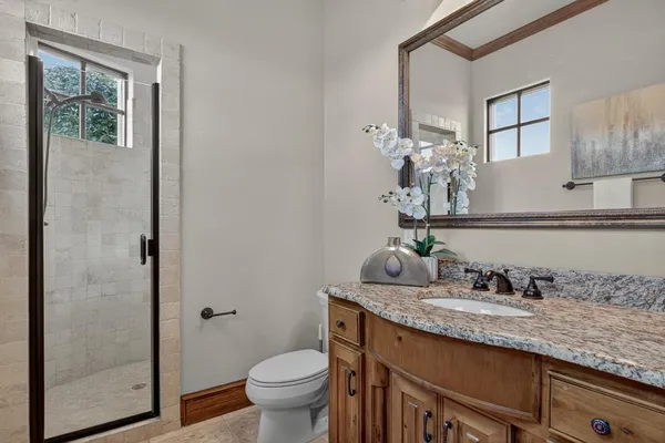 a bedroom with a bed dresser and a flat tv screen