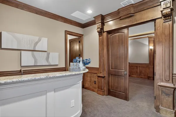 a bathroom with a granite countertop sink mirror and cabinets