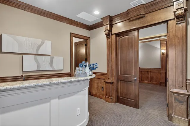 a bathroom with a granite countertop sink mirror and cabinets