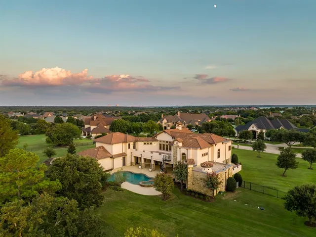 a view of a city with lawn chairs and large trees
