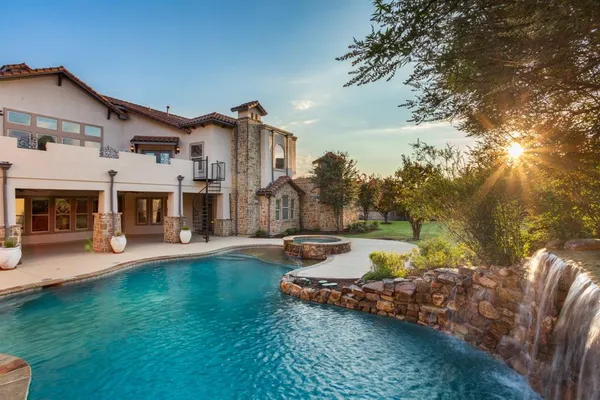 a view of a house with swimming pool and sitting area
