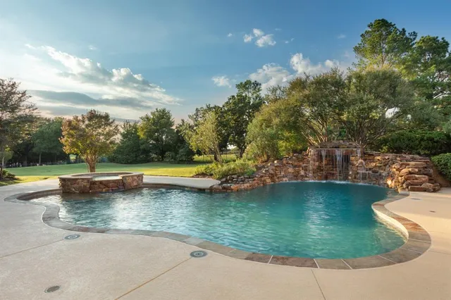 a view of a swimming pool with a yard
