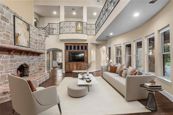 a living room with furniture fireplace and a large window