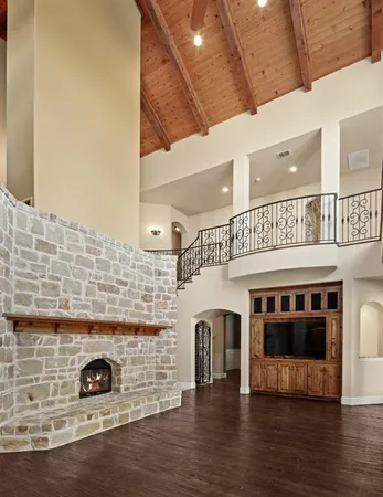a living room with a fireplace and wooden floor