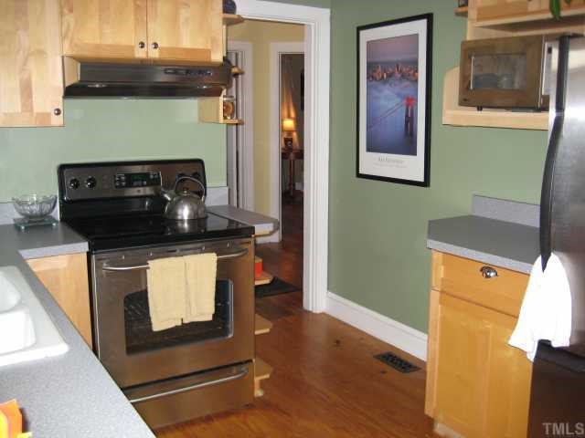 506 Burton Street Raleigh, NC 27608 - Photo 2 of 6 a kitchen with a refrigerator and a stove