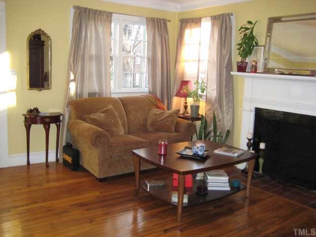 506 Burton Street Raleigh, NC 27608 - Photo 3 of 6 a living room with furniture and a fireplace