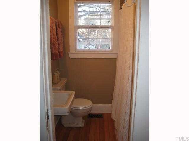 506 Burton Street Raleigh, NC 27608 - Photo 6 of 6 a bathroom with a toilet a sink and a window
