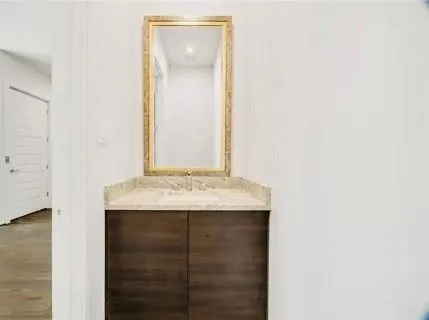 a view of an empty room and kitchen view