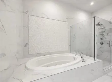 a bathroom with a tub sink and mirror