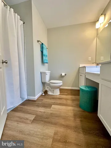 a bedroom with a bed and a night stand