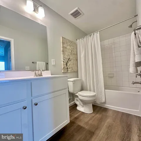 a bed sitting in a room next to a window