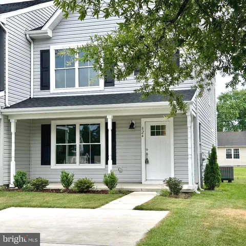 a house that has a tree in front of the house