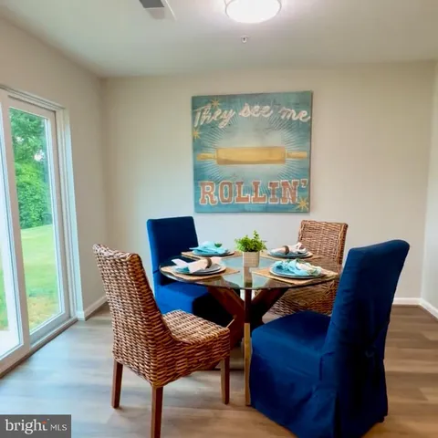 a dining room with furniture and wooden floor
