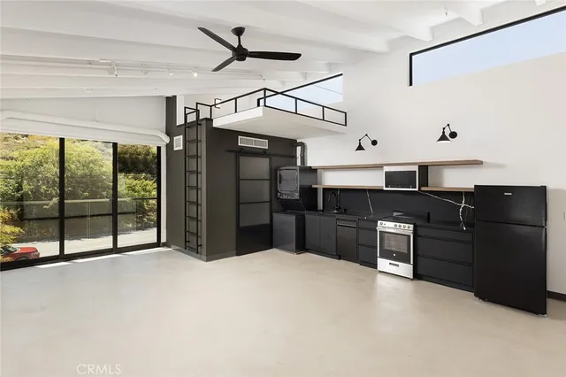 a kitchen with stainless steel appliances granite countertop a refrigerator and wooden cabinets