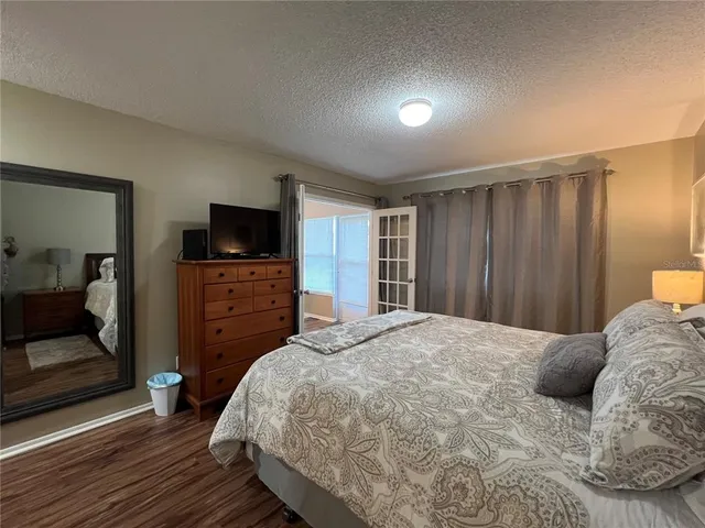 a bedroom with a bed and a television