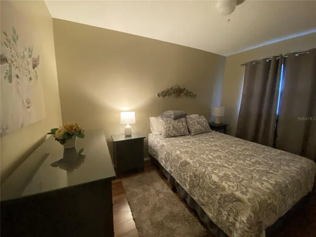 a bedroom with a bed and a dresser