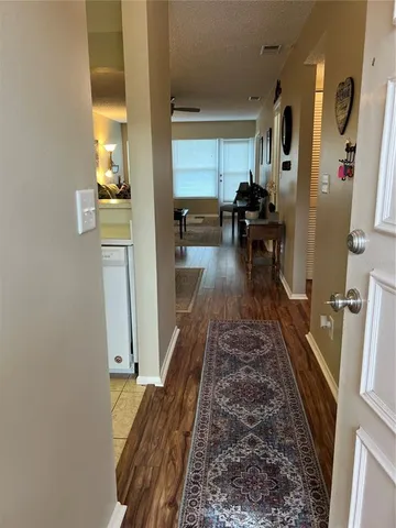 a hallway with a view of living room