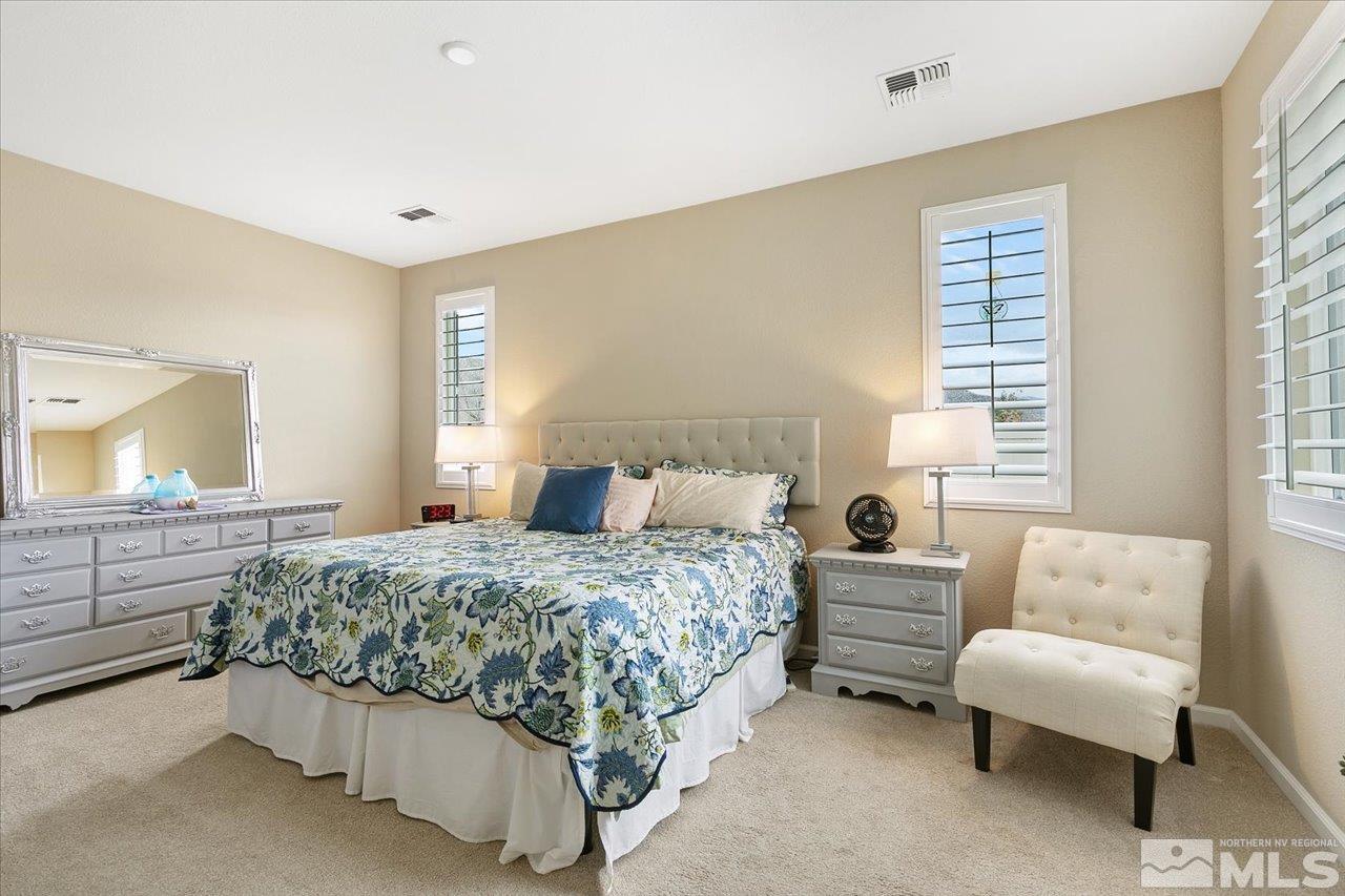 2280 Trakehner Lane Reno, NV 89521 - Photo 11 of 24 a bedroom with a bed and a couch
